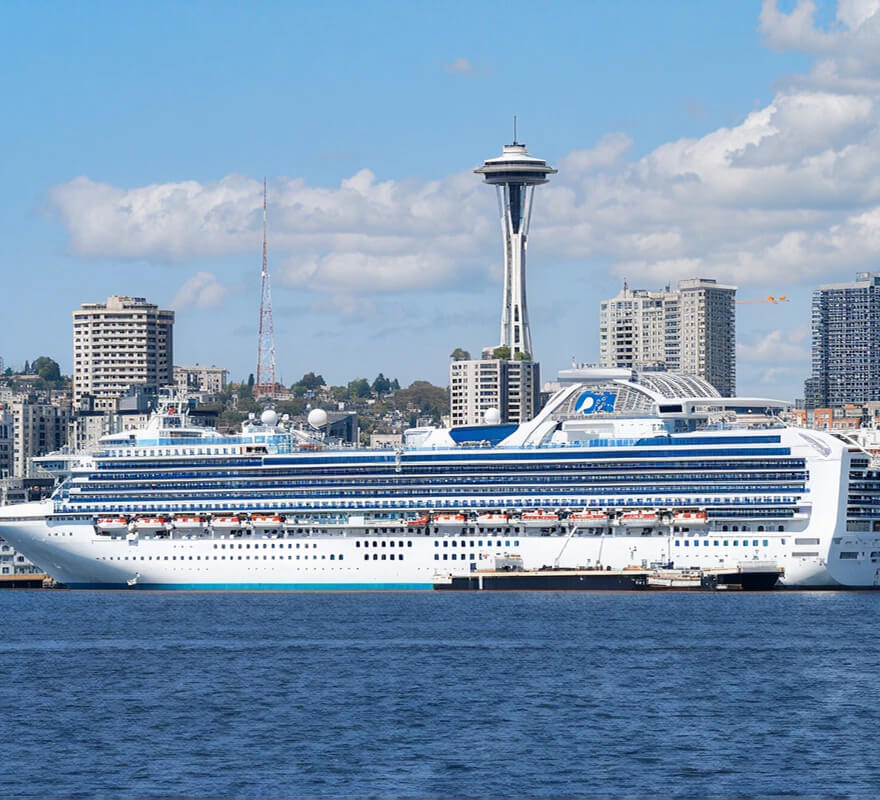 Princess Cruises ship docked at the Seattle terminal with the Space Needle visible in the background